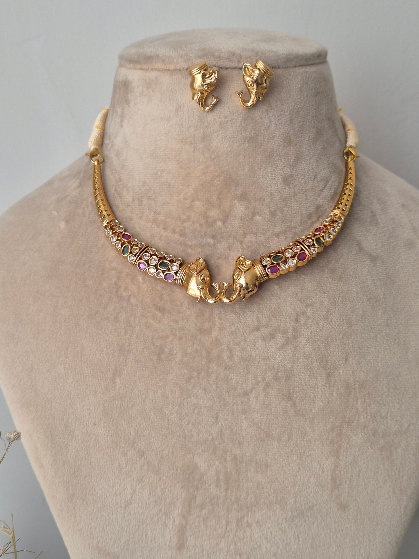 Trunkful of Love enchance your look and your strength with golden elephant face necklace and earring with colourful stones by naitr.in
