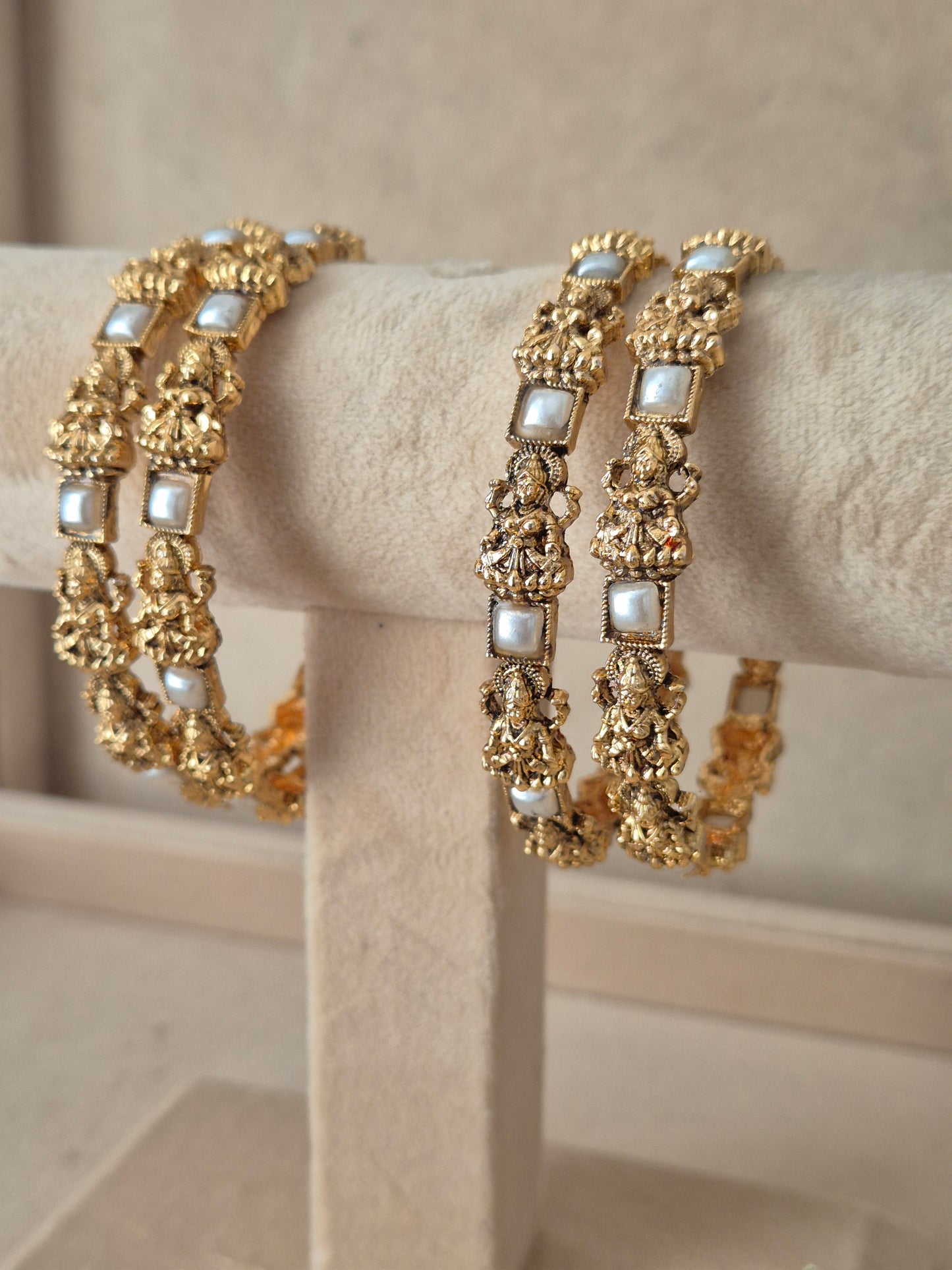 Four ethnic antique gold-plated temple jewelry bangles with with white square beads, for festive and wedding wear by naitri.in