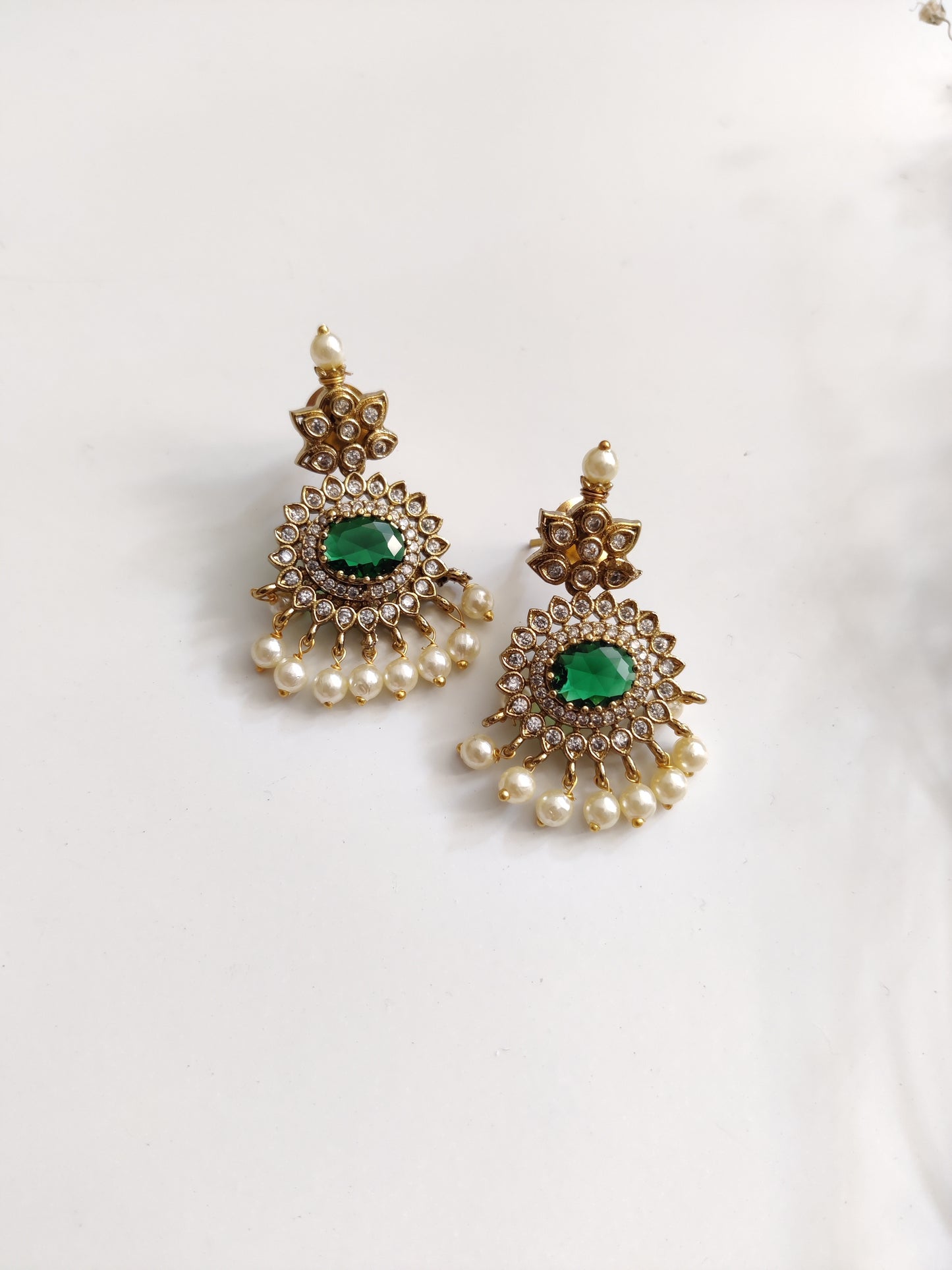 Elegant temple necklace with gold and green details, showcased with focus on delicate metalwork