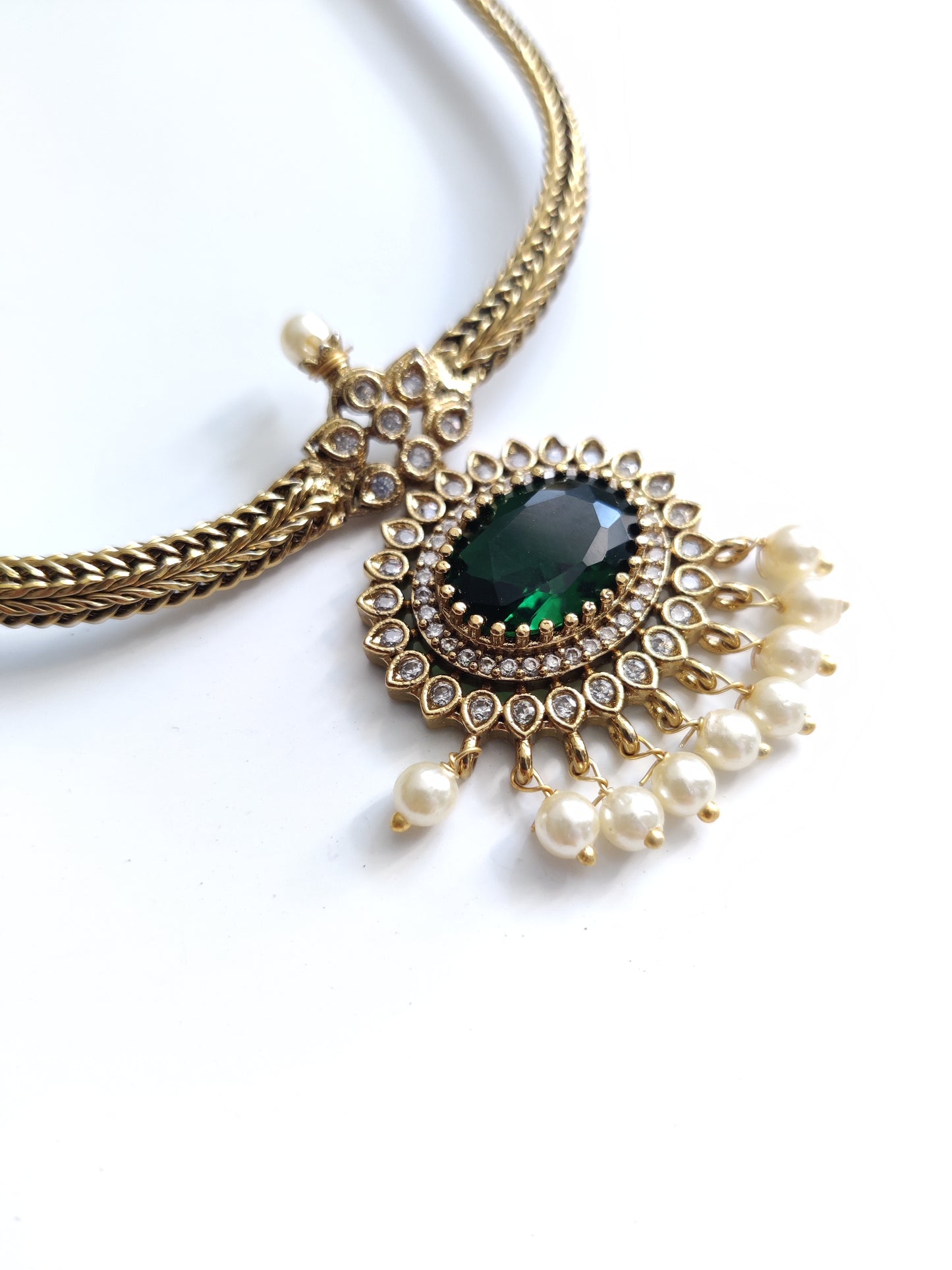 Elegant temple necklace with gold and green details, showcased with focus on delicate metalwork