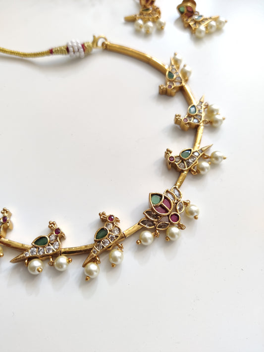 Classic gold-tone necklace set in metal alloy, photographed to highlight smooth finish and traditional look