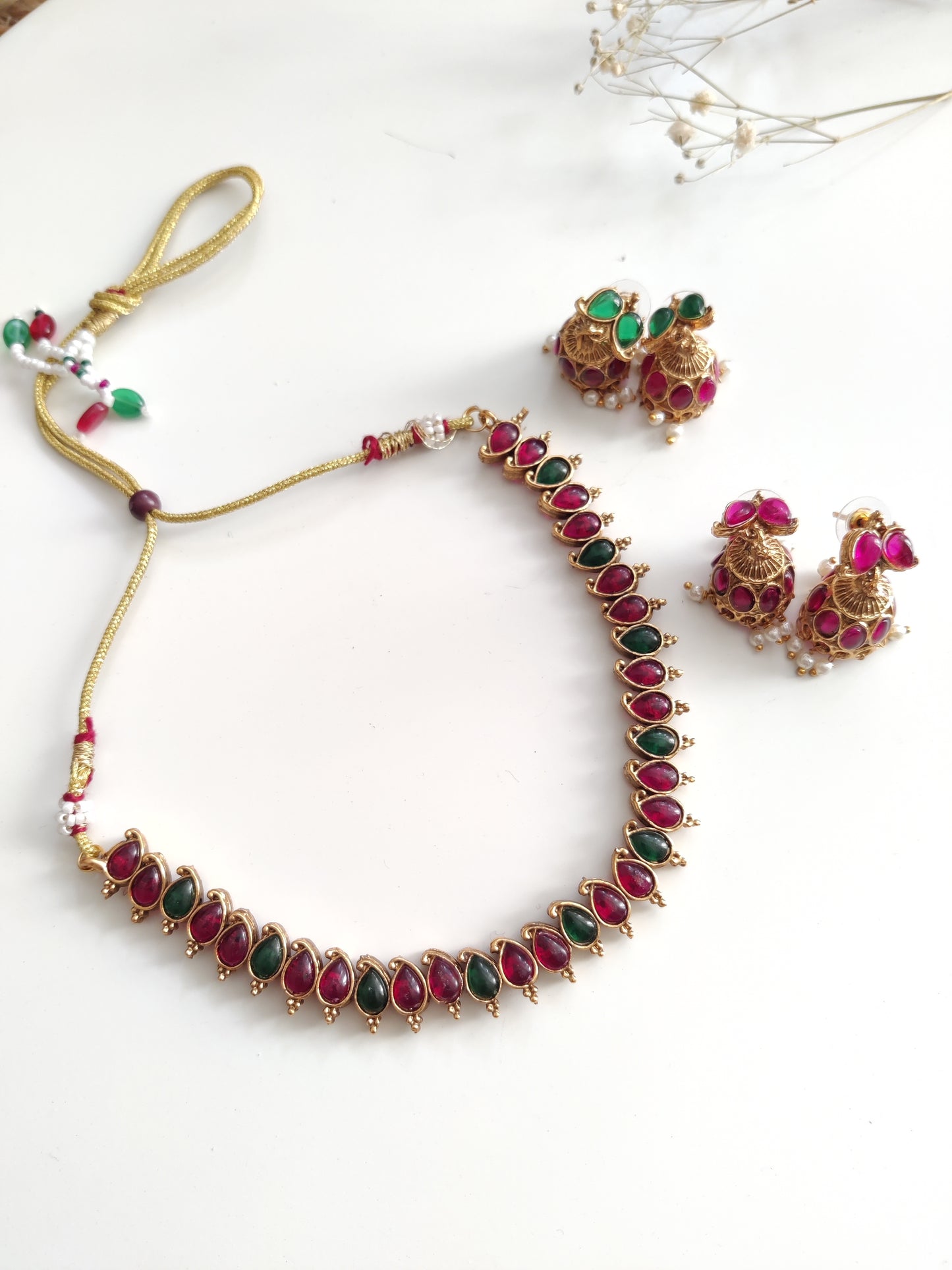 Unique reversible necklace set with pink, red, and green enamel, shown from multiple angles to illustrate versatility