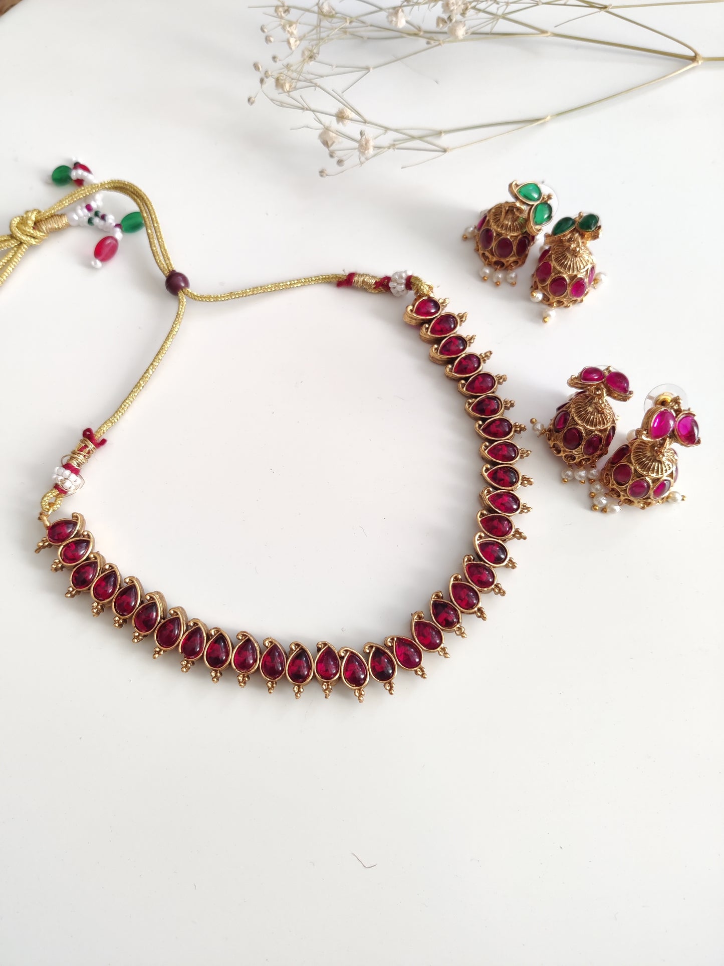 Unique reversible necklace set with pink, red, and green enamel, shown from multiple angles to illustrate versatility