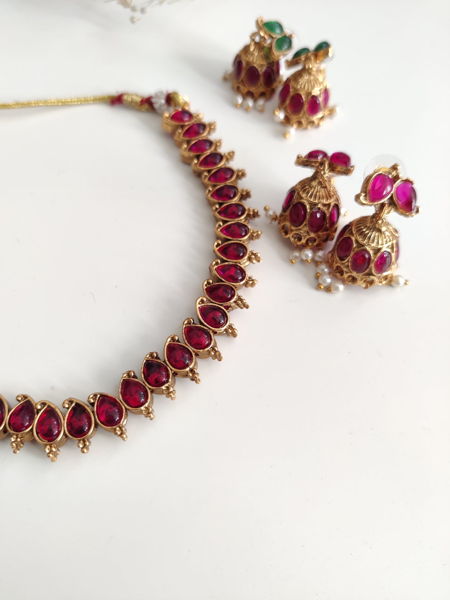 Unique reversible necklace set with pink, red, and green enamel, shown from multiple angles to illustrate versatility