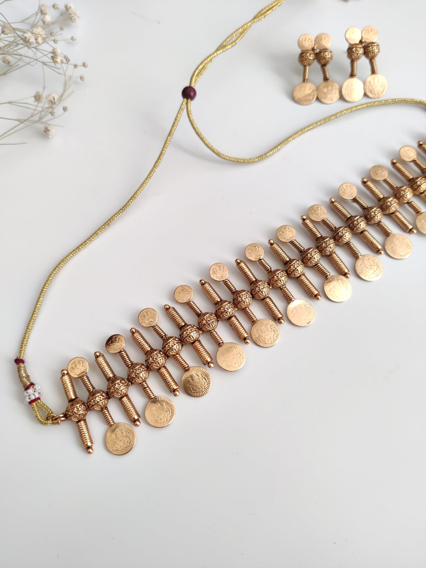 Refined temple necklace set in metal alloy with gold accents, displayed to showcase intricate detailing