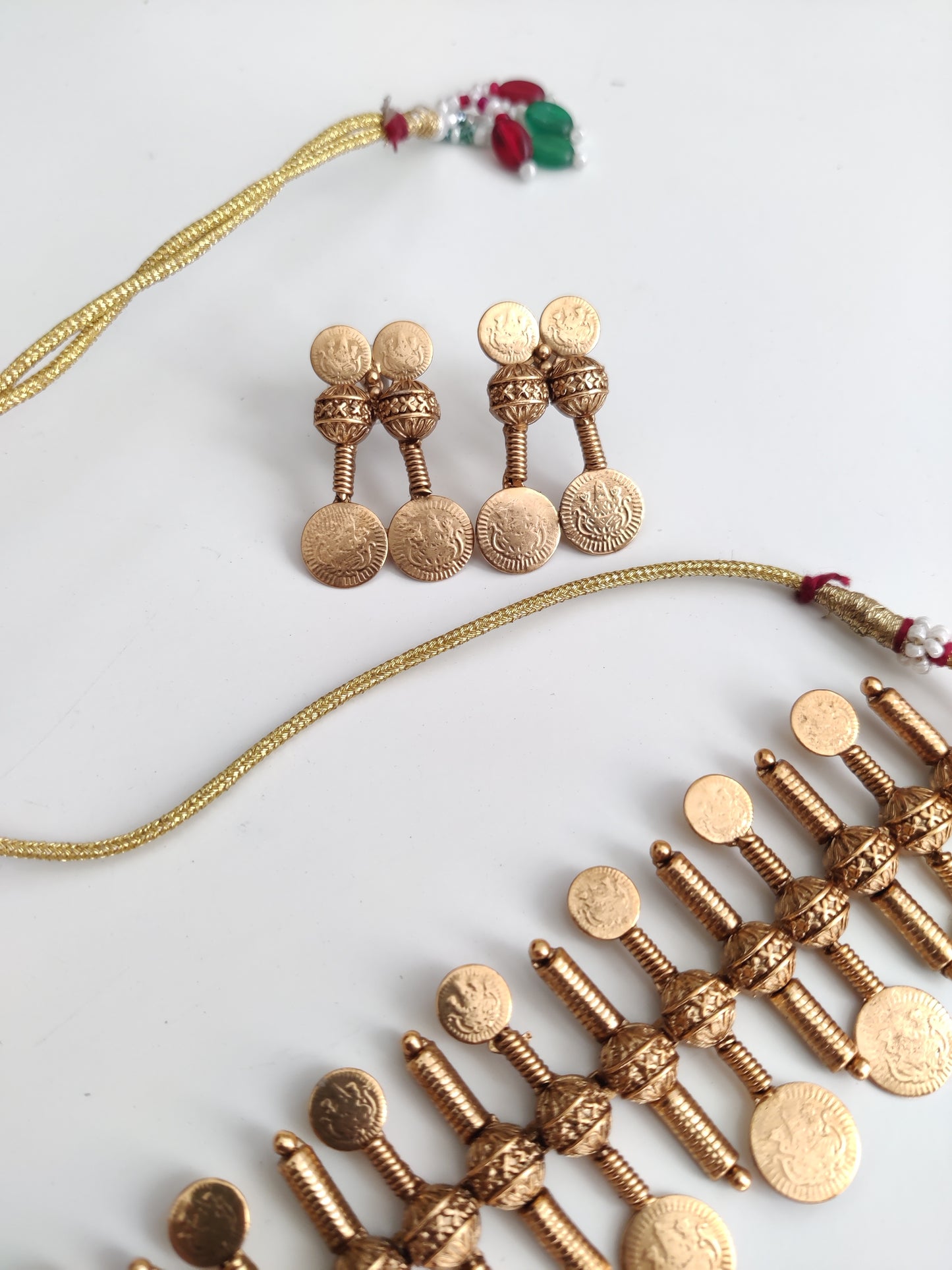 Refined temple necklace set in metal alloy with gold accents, displayed to showcase intricate detailing