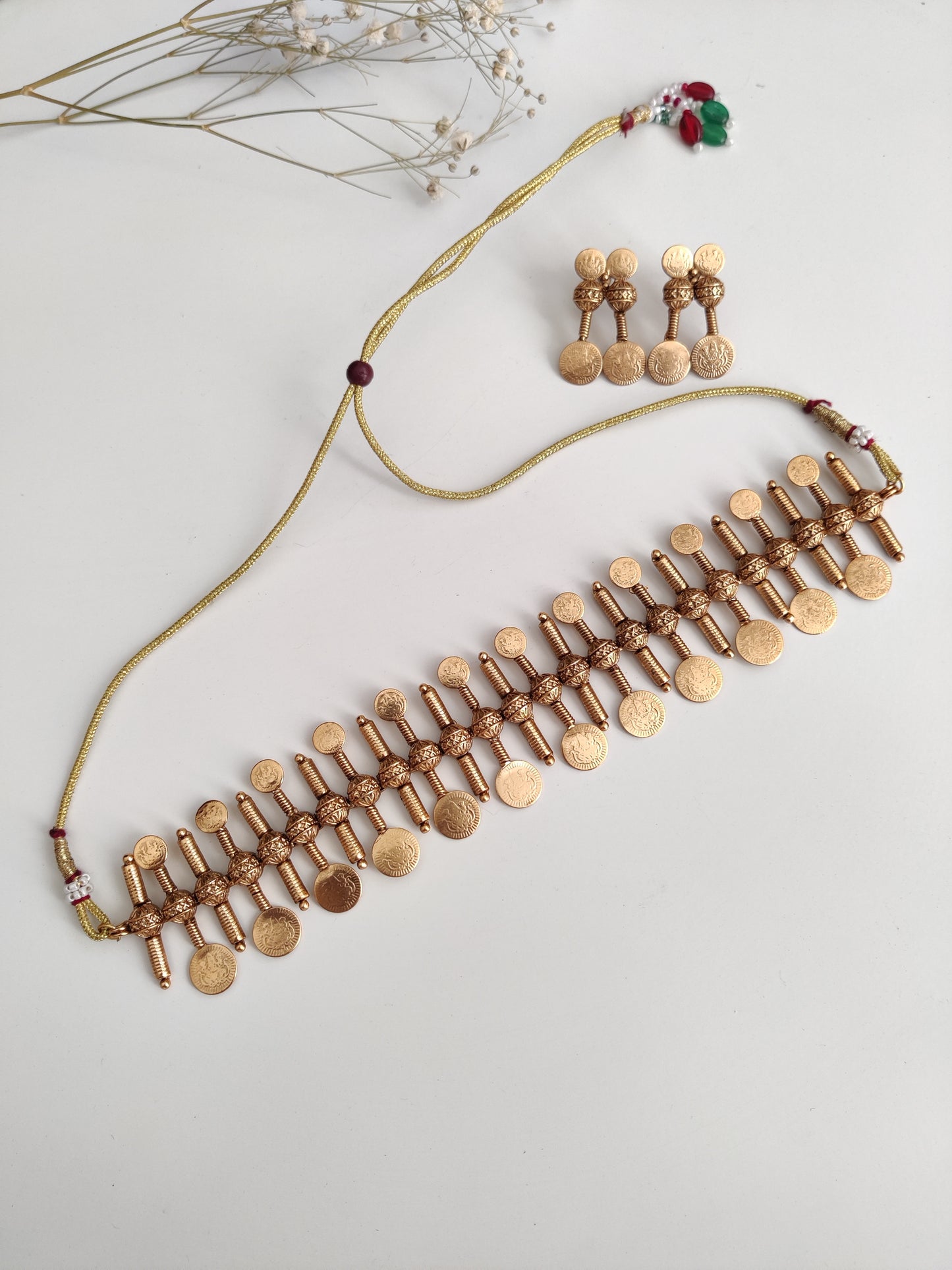 Refined temple necklace set in metal alloy with gold accents, displayed to showcase intricate detailing