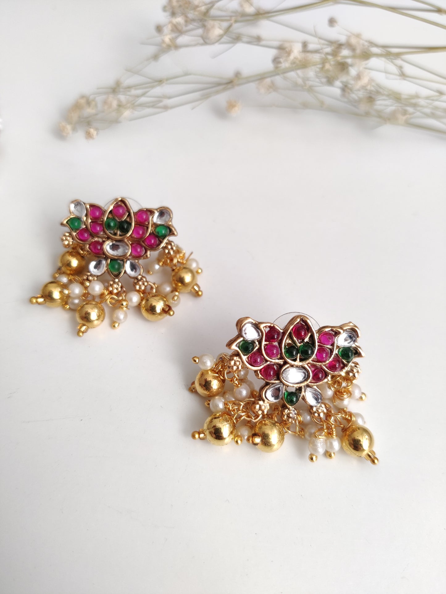 Temple necklace set with stud and dangle elements in gold-tone metal alloy, emphasizing detailed craftsmanship