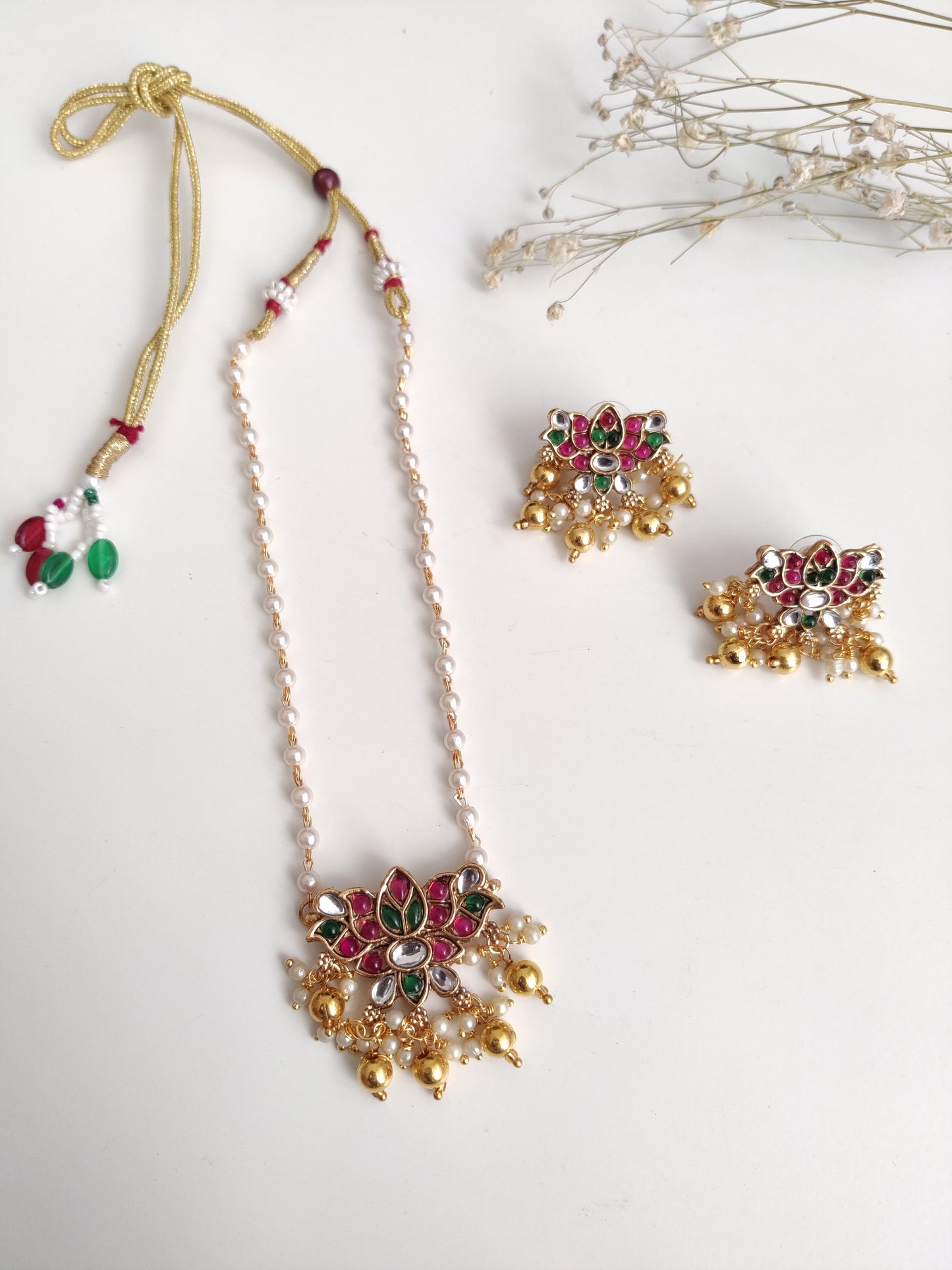 Temple necklace set with stud and dangle elements in gold-tone metal alloy, emphasizing detailed craftsmanship