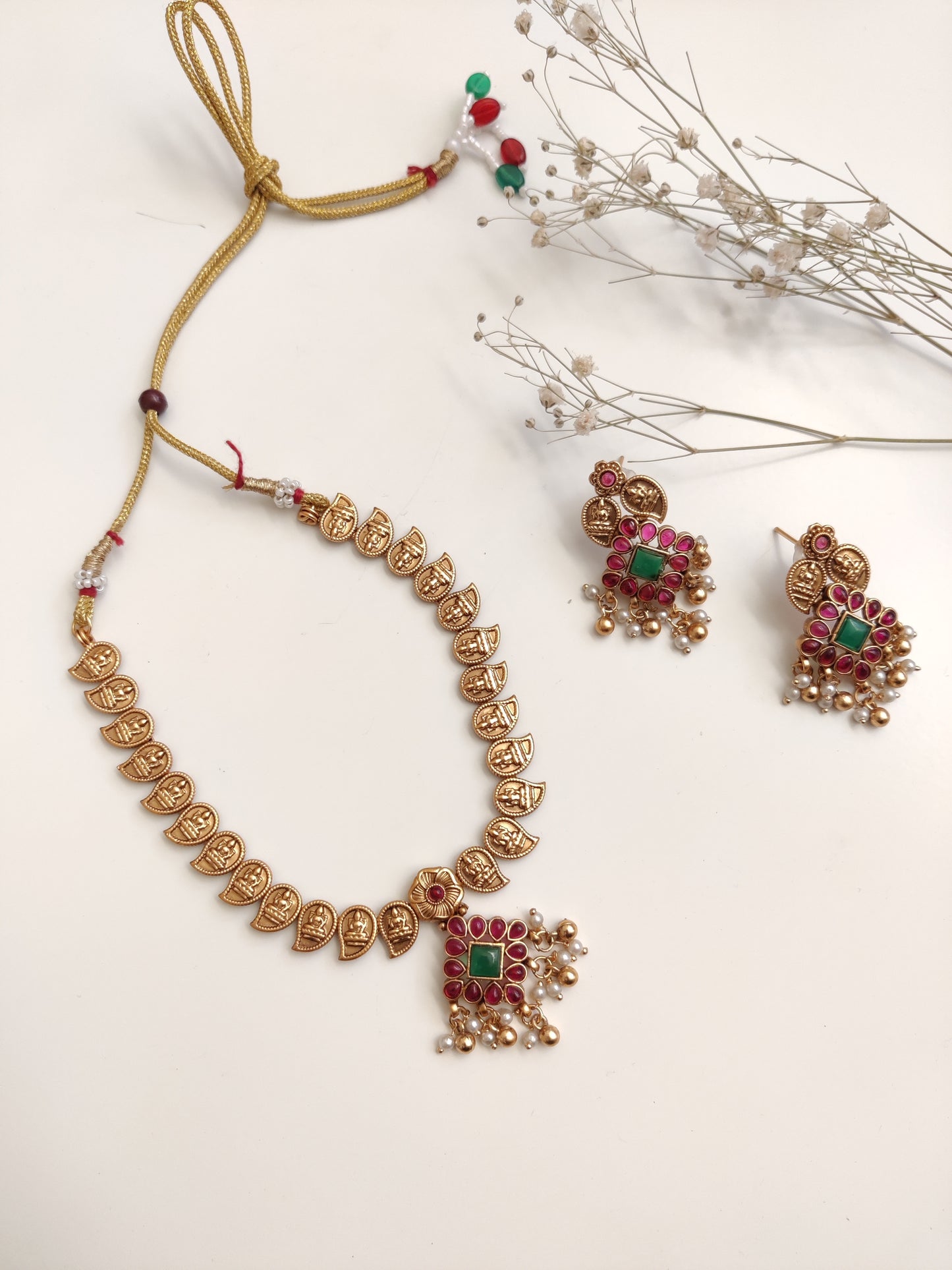 Majestic gold-tone temple necklace set in metal alloy featured to highlight intricate design and shine