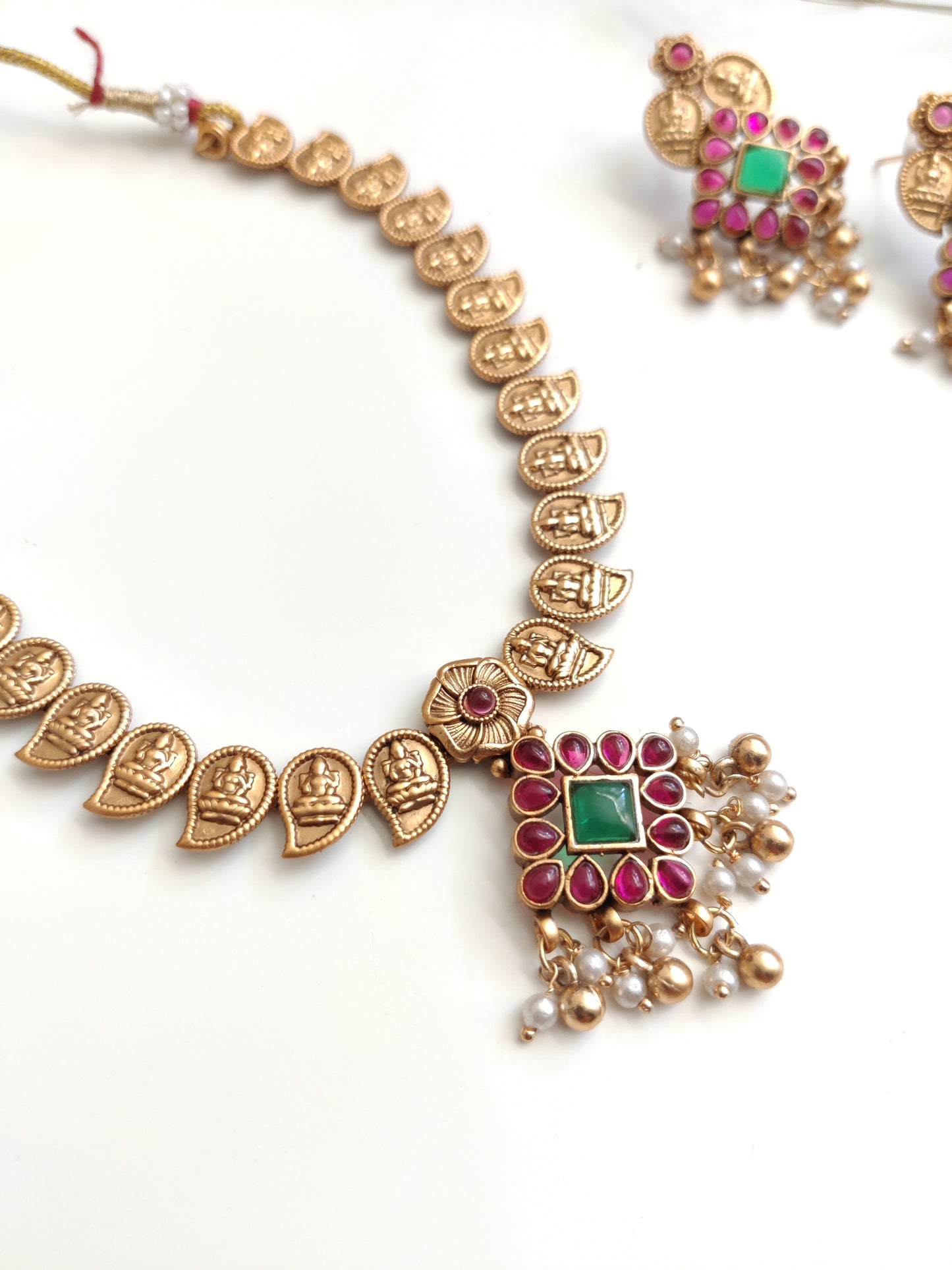 Majestic gold-tone temple necklace set in metal alloy featured to highlight intricate design and shine