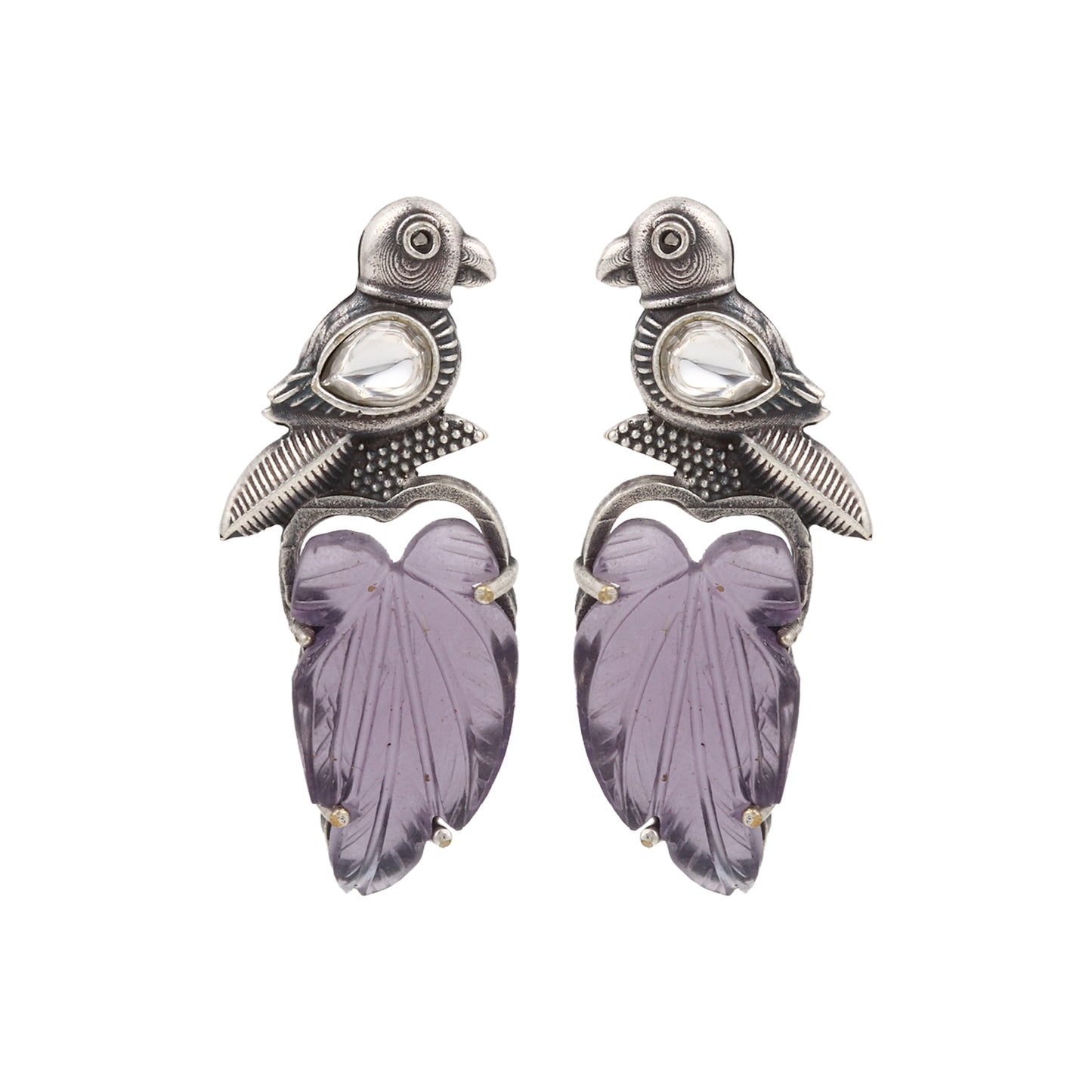 Purple stud earrings with stonework, displayed on a jewelry stand