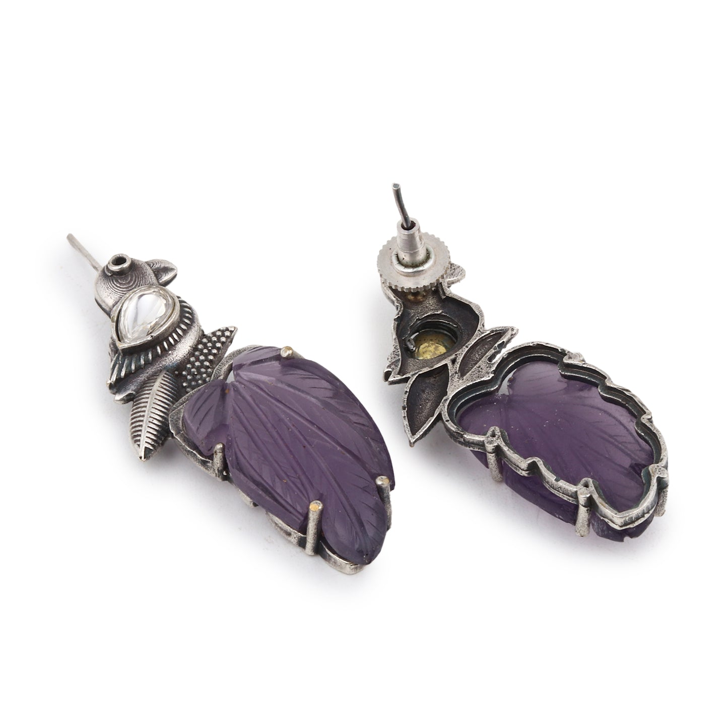Purple stud earrings with stonework, displayed on a jewelry stand