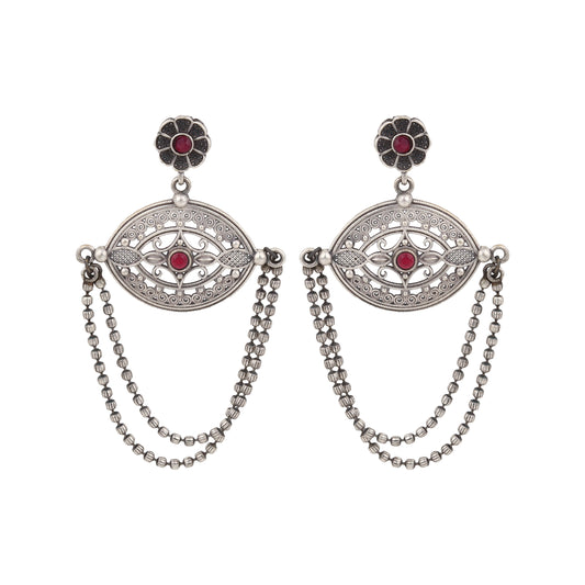 Silver-tone, traditional brass stud earrings shown on dark background