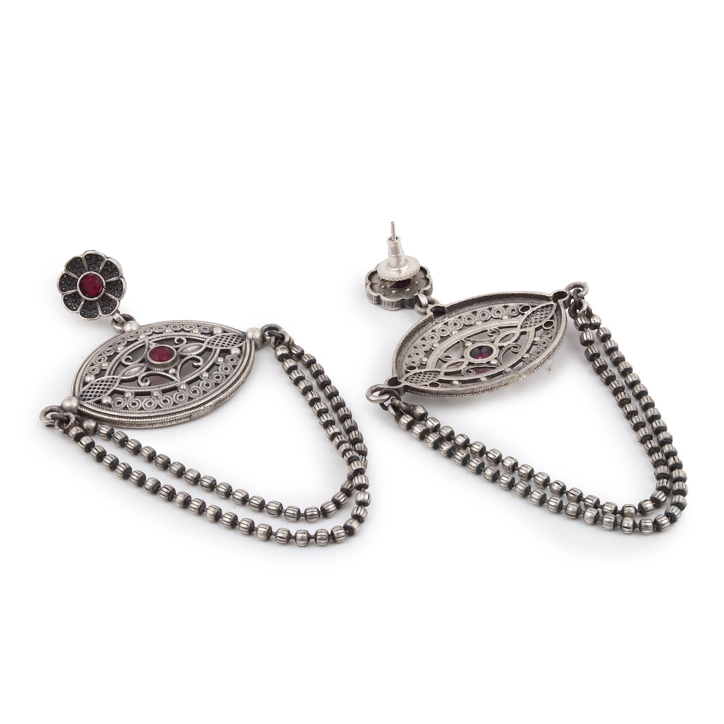 Silver-tone, traditional brass stud earrings shown on dark background