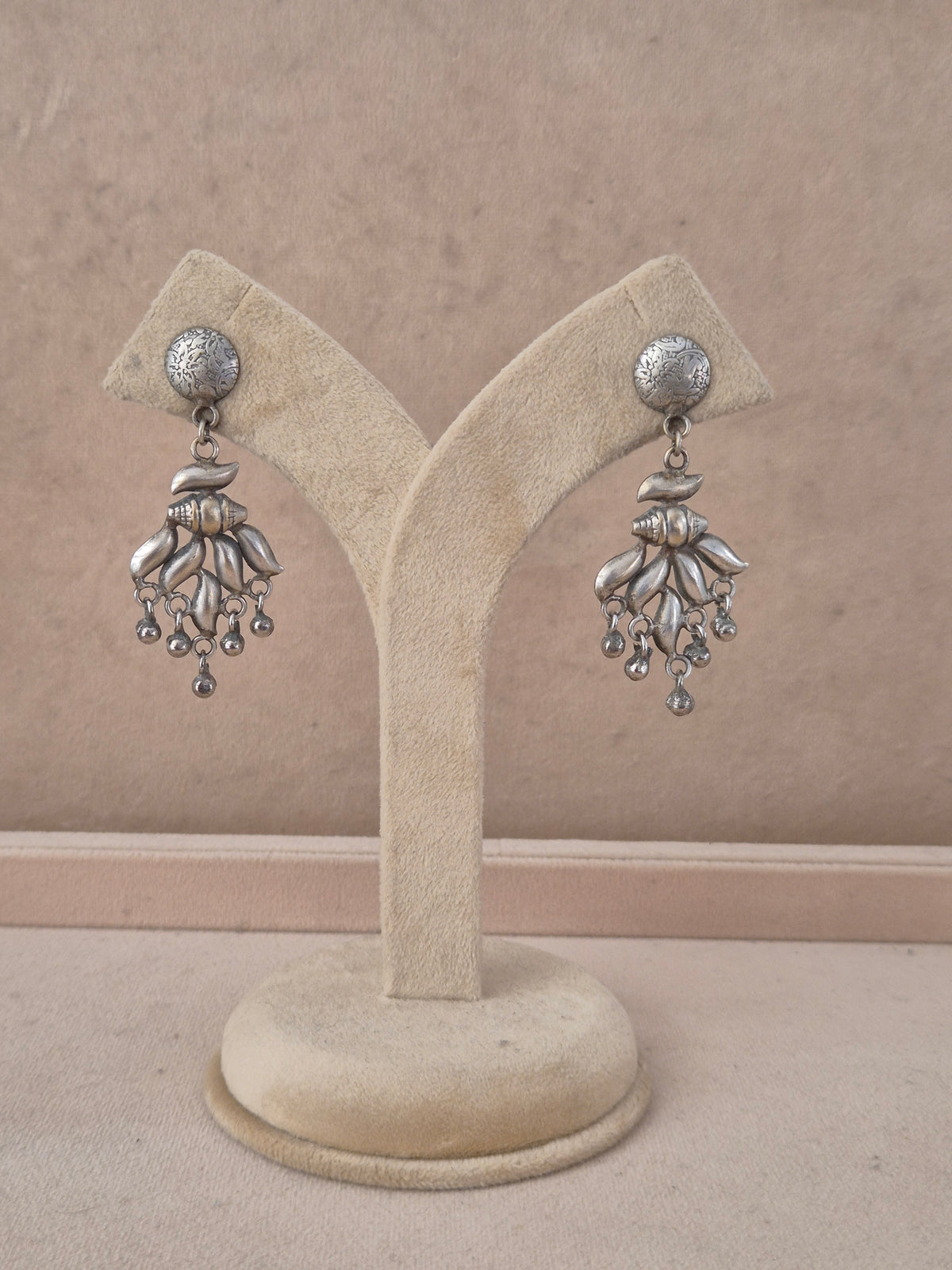 A pair of silver-toned dangle earrings Handcrafted silver-toned dangle earrings artisanal silver oxidized chandelier earrings with hanging bead accents by naitri.in