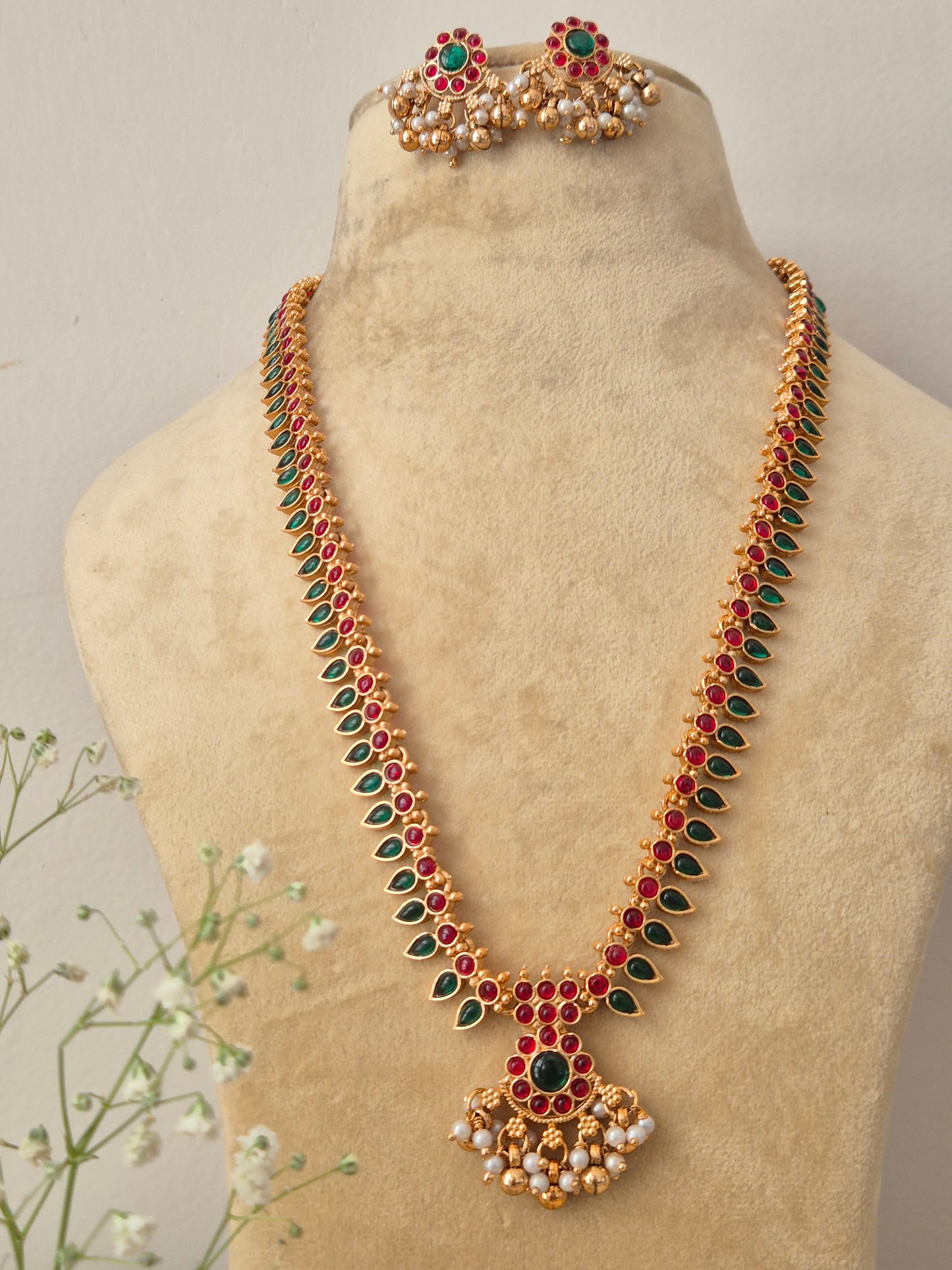 Elegant traditional gold-toned ethnic necklace set with intricate gemstone detailing by naitri.in