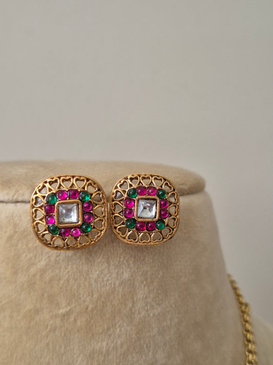Traditional Laksh earring in antique gold finish with pink and green stone embellishments by naitri.in