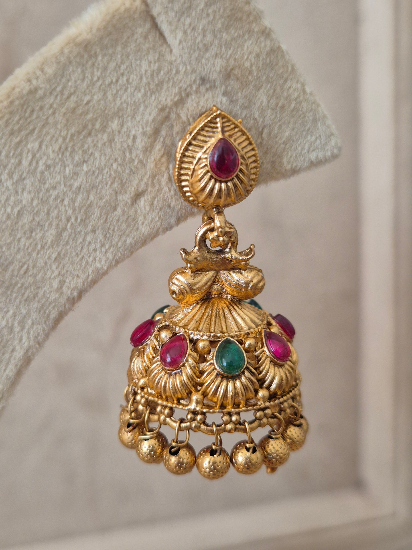 Gold earrings with red and green stones, Handcrafted in brass with red and green stones and a polished gold by naitri.in