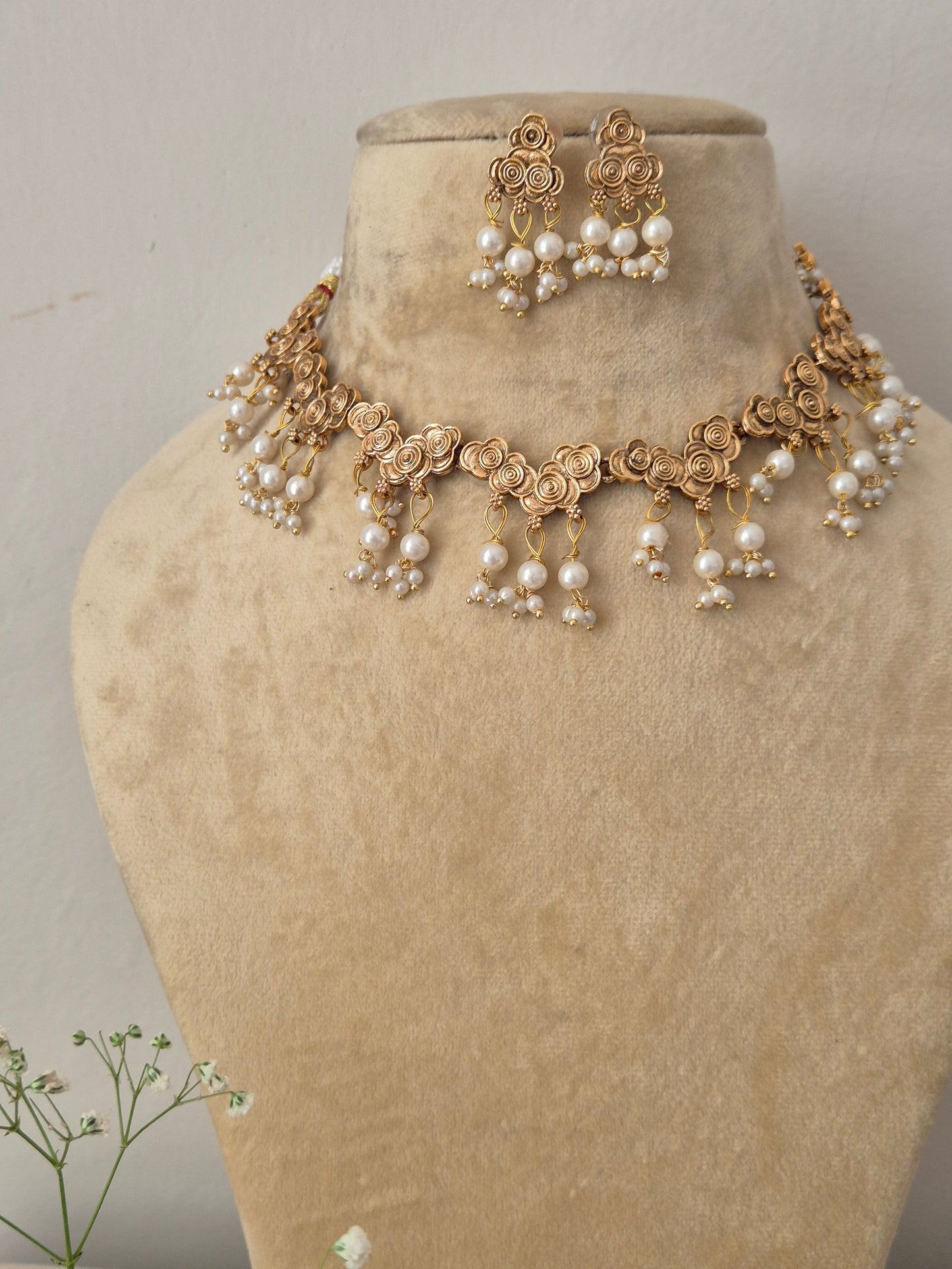 Elegant gold-toned ethnic choker jewelry set with intricate pearl hangings, by naitri.in