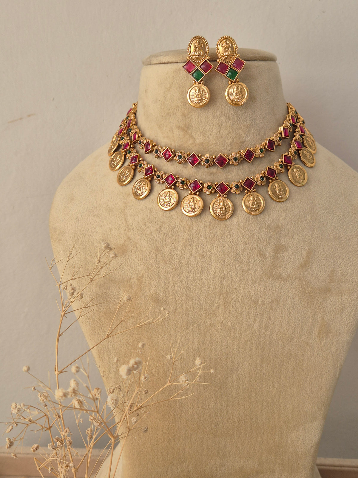 Traditional Indian ethnic gold necklace and earring set with gemstone details by Naitri.in