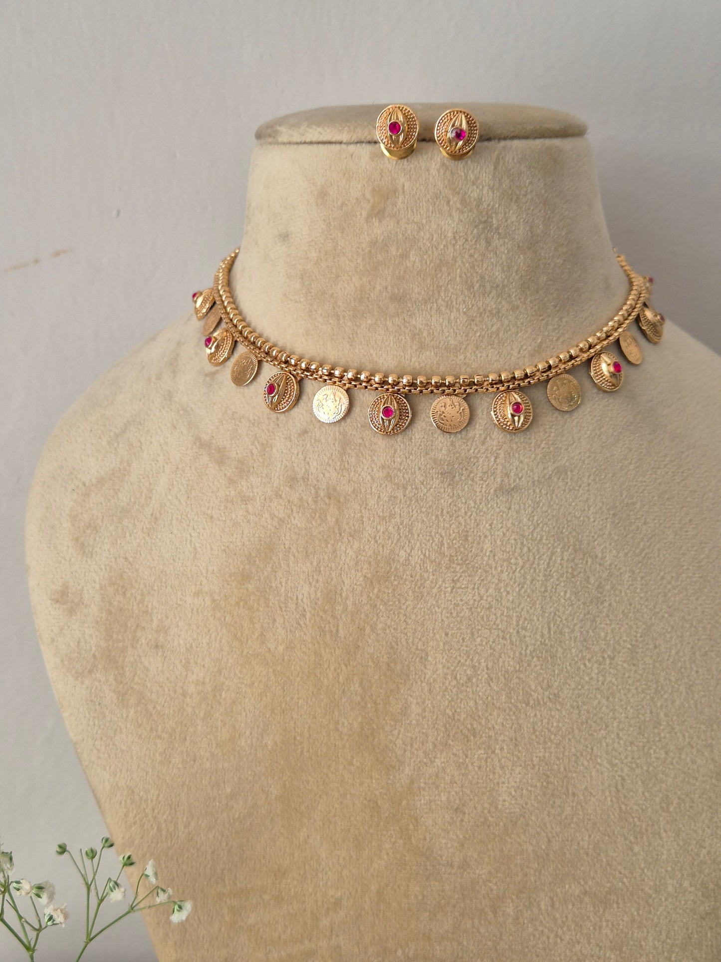 Traditional Indian style golden brass alloy choker necklace and matching stud earrings from the NAITRI ethnic jewelry collection by naitri.in