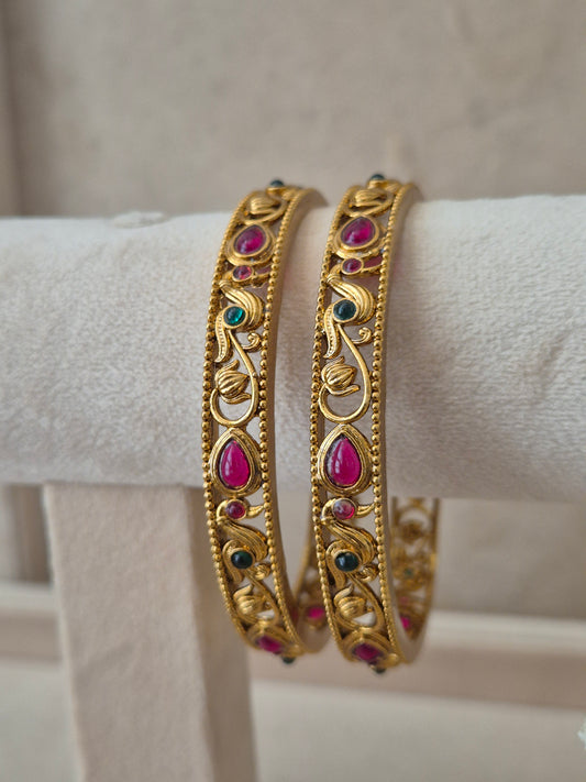 Aadra Bangles set of 2, traditional Indian gold-plated bangles with red and green stones, ethnic bridal and festive jewelry by Naitri.in