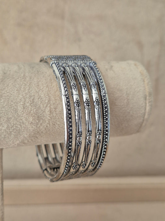 Close-up of Naitri Basanti premium oxidized silver cuff bangle showcasing traditional Indian tribal jewelry craftsmanship with a vintage antique finish by naitri.in