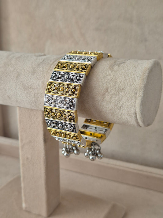 Dual-tone Binita bangle bracelet featuring an alternating pattern of textured gold and oxidized silver rectangular blocks with tiny gold bead borders
