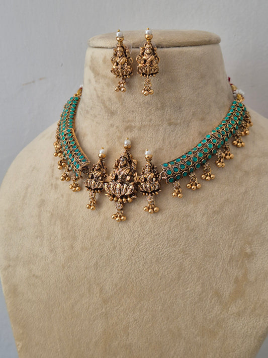Gold-plated choker necklace and matching drop earrings with turquoise blue stone inlay and small white pearl accentsby naitri.in