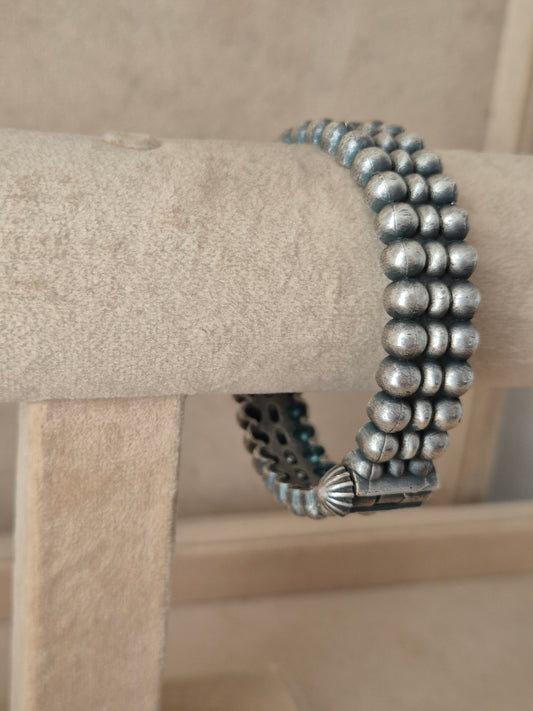 Close-up of Naitri premium silver oxidized bangle bracelet featuring traditional Indian style metalwork and a secure hinge clasp by naitri.in