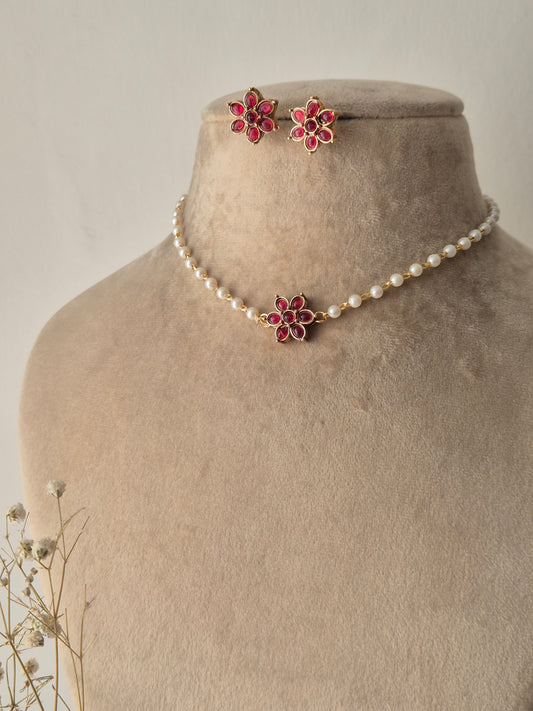 Naitri Heer Choker Set featuring white pearls and pink floral stone work by naitri.in