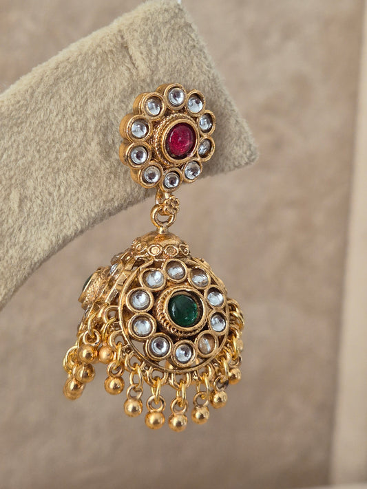 traditional gold-plated ethnic jhumka earrings featuring a circular floral stud studded with ruby-red and emerald-green stones, with tiny pearl drops by naitri.in