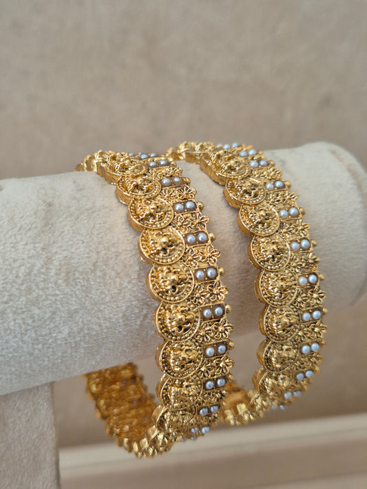 Close-up of Naitri Kanishka premium gold ethnic bangle set with traditional Indian festive craftsmanship and small pearl bead details by naitri.in