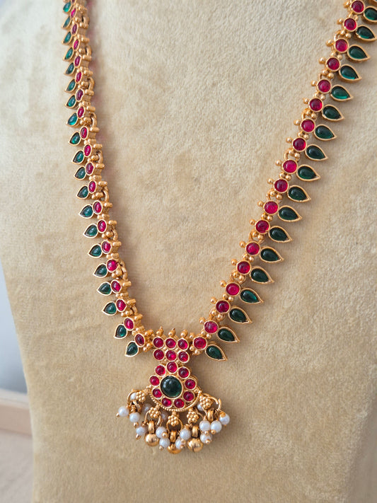 Modern Indian ethnic imitation jewelry set including a textured golden chain necklace embedded with ruby red and emerald green stones, by naitri.in