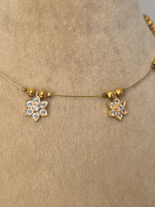 Minimalist gold-toned fine chain necklace adorned with evenly spaced hanging square pendants set with clear crystals or gemstones, by naitri.in