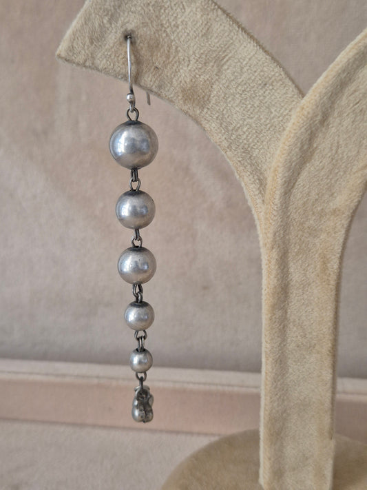 Elegant minimalist silver drop earrings featuring multiple graduated metallic beads on delicate wire hooks by naitri.in
