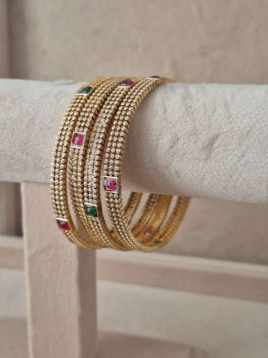 Savya Bangles set of 4, traditional Indian gold-plated bangles with red and green stones, ethnic festive and bridal jewelry collection by Naitri.in