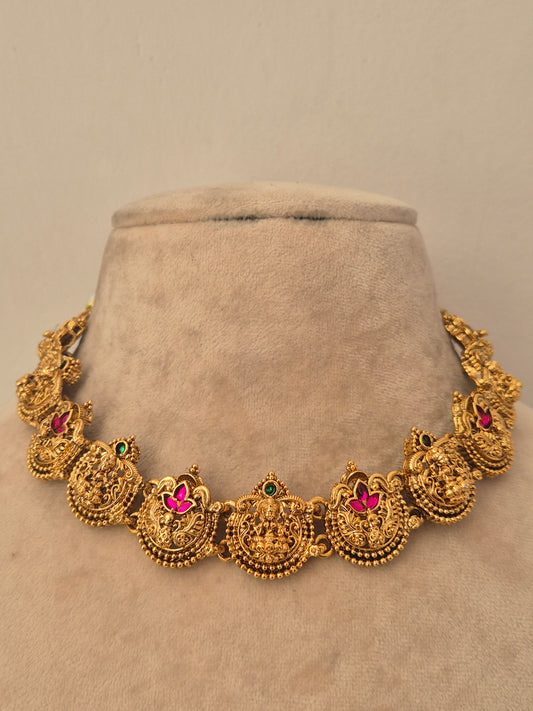 Traditional gold temple choker necklace with round peacock motifs featuring pink ruby stone centers and small green gem accents, by naitri.in