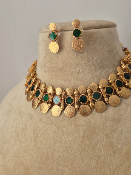 Traditional Indian gold coin choker necklace paired with matching textured round earrings, showcasing an antique finish from the Naitri Golden Ethnic Jewellery collection by naitri.in