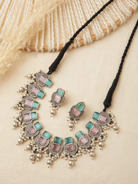 Silver and green choker necklace set, Rishika by Naitri, displayed flat.