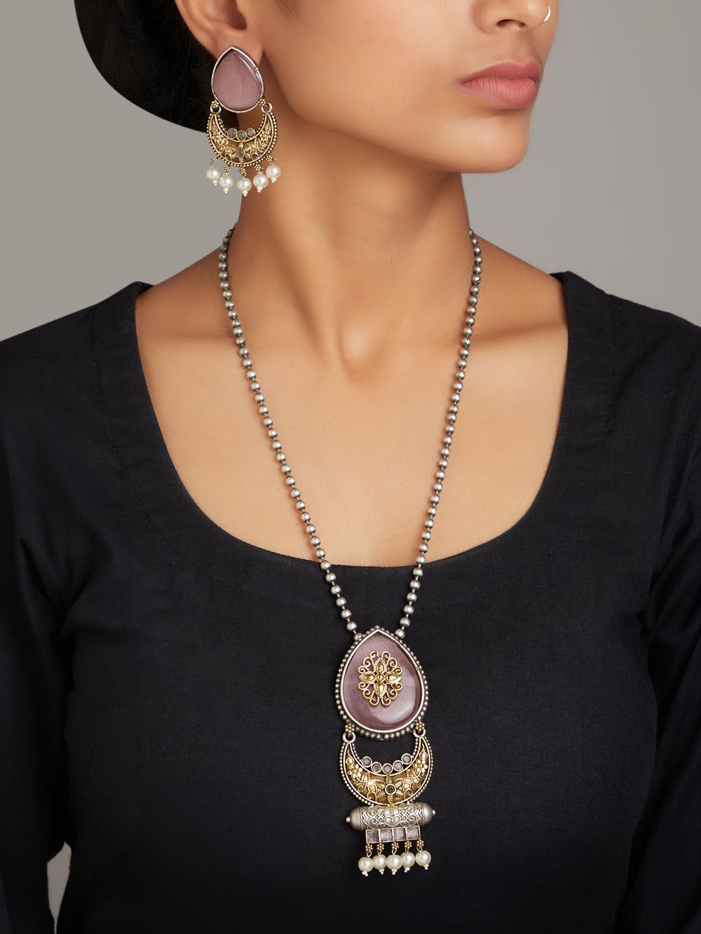 Brass choker necklace set with pink and silver pendant, luxurious display