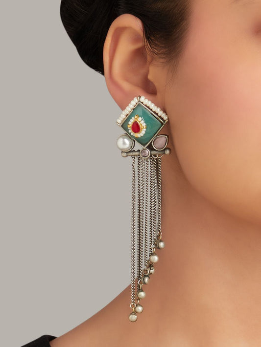 Green and blue stud earrings, Isharya by Naitri on plain display card.