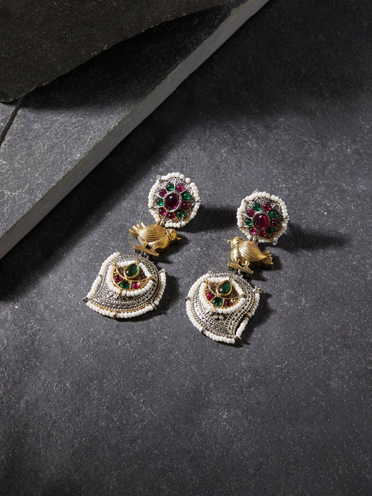 Red and silver stud earrings, Rimisha by Naitri, festive design on display.