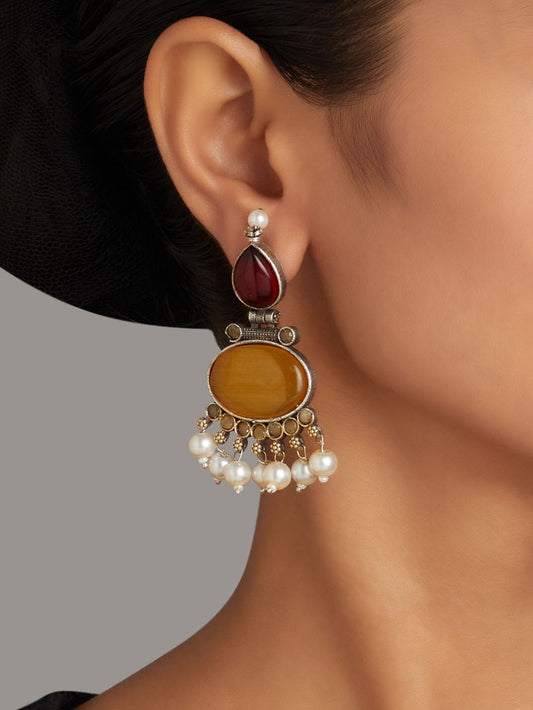 Red and yellow stud earrings, Bindu by Naitri, festive colorful design.