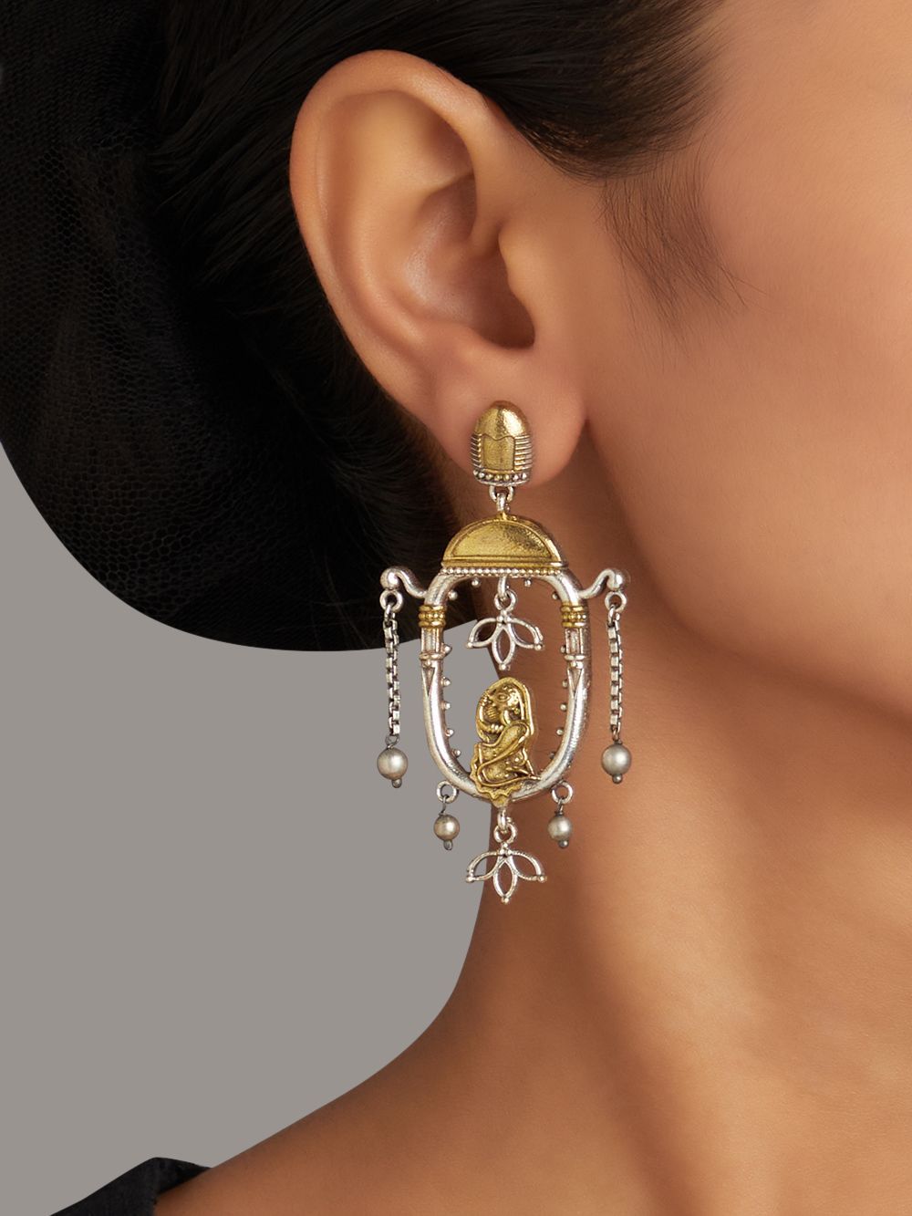 Red and gold stud earrings with bold stone embellishments