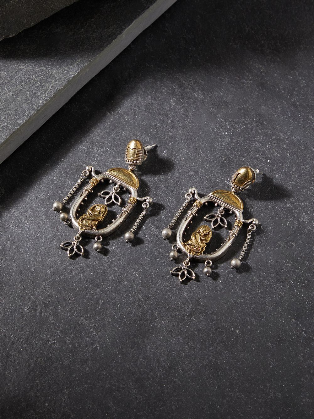 Red and gold stud earrings with bold stone embellishments