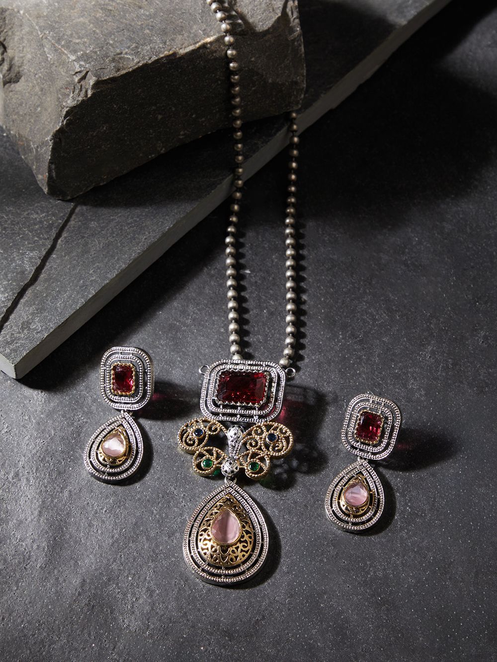 Red pendant necklace set, Vira by Naitri, statement jewelry on soft background.