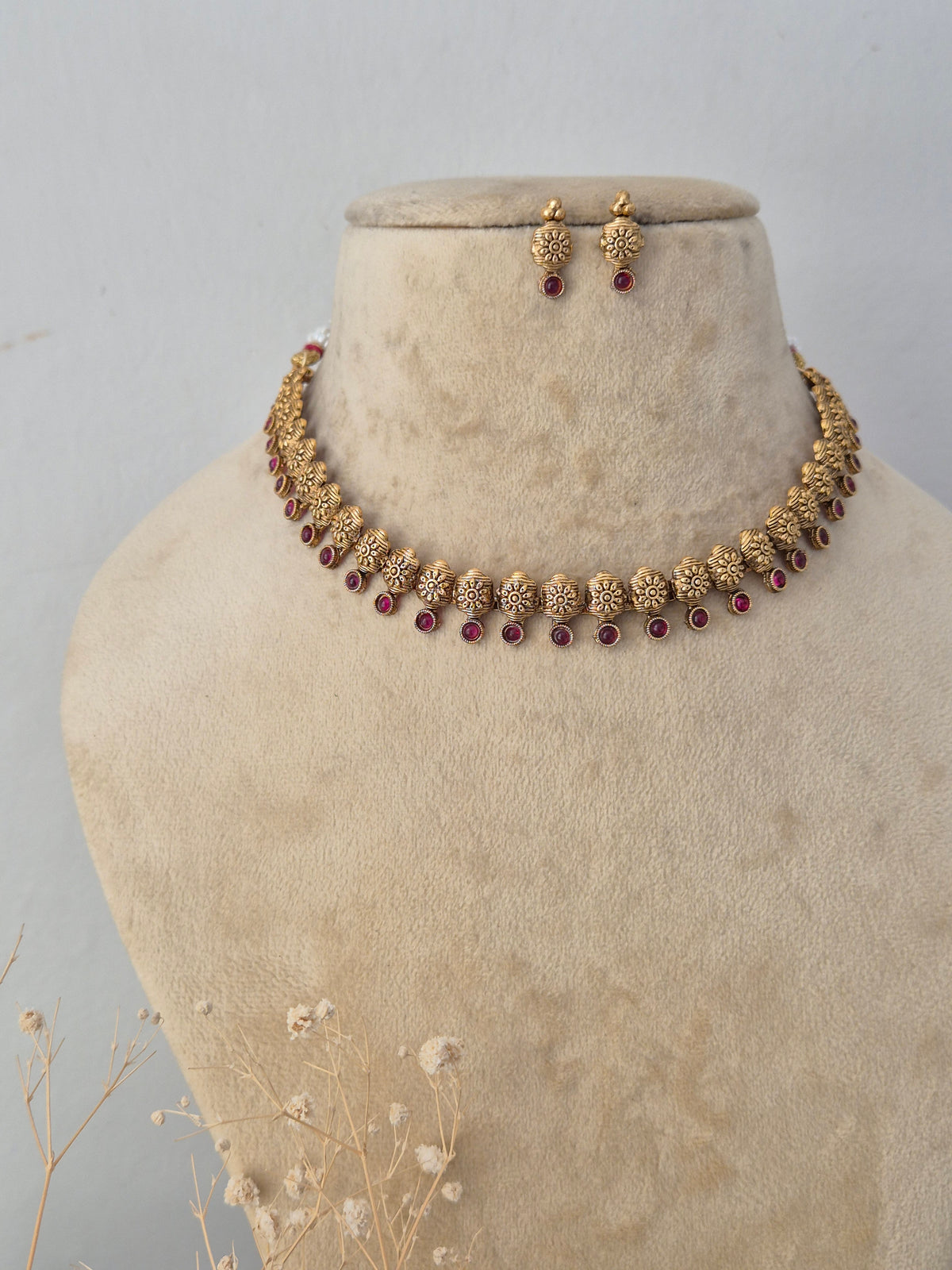 Handcrafted brass alloy traditional Indian necklace set with intricate deity carvings and stone embellishments by Naitri.in