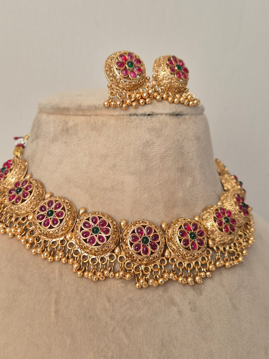 Traditional matte gold necklace set with embossed floral clusters and hanging gold bead drops, featuring intricate leaf engravings
